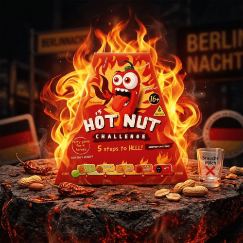 Rote, pyramidenförmige Verpackung der "Hot Nut Challenge - 5 steps to HELL" mit brennender Chili-Figur, umgeben von echten Flammen, Erdnüssen und Chilis.